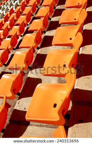 Rows of plastic chair in football stadium