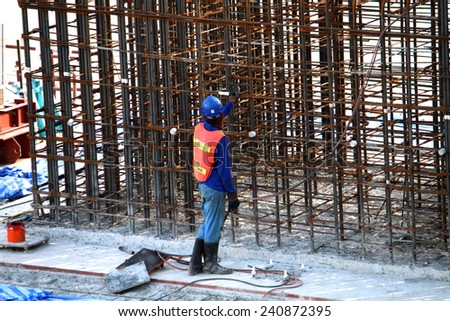 NONTHABURI-THAILAND-SEPTEMBER 20 : The worker for construction concrete bridge over the river at worksite on September 20, 2014, in Nonthaburi, Thailand