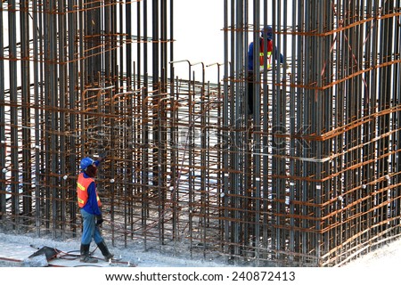 NONTHABURI-THAILAND-SEPTEMBER 20 : The worker for construction concrete bridge over the river at worksite on September 20, 2014, in Nonthaburi, Thailand