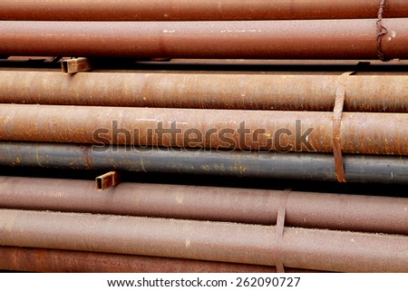Rust steel pipes bunch on the rack in warehouse