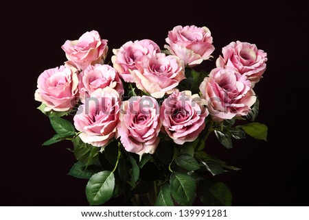 bouquet of artificial roses on a black background