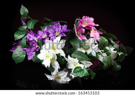 bouquet of artificial clematis isolated on a black background