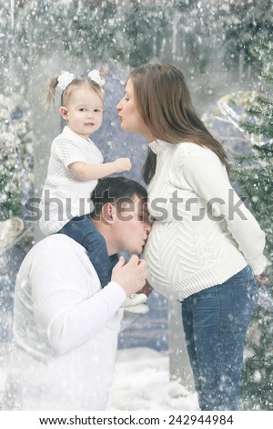happy young family on a snow-covered terrace