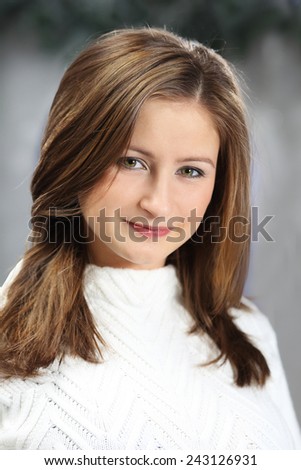 portrait of a young pretty girl of Caucasian appearance in the warm bright sweater