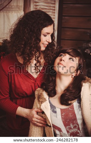 Mother and daughter looking at each other rustic Christmas Interior