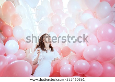 flying girl surrounded by a vast number of pink and white balloons