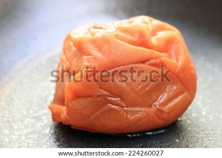 A pickled plum or dried plum called  umeboshi in Japan