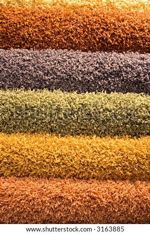 Multi-coloured fluffy carpets for a background. Multi-coloured floor coverings.