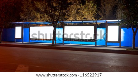 night bus station with blank billboard