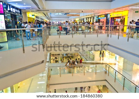 CHENGDU,CHINA - AUG 6,2011: People in the shopping mall at night.This is a big mall at chengdu,china.It is named WanDa plaza shopping mall.