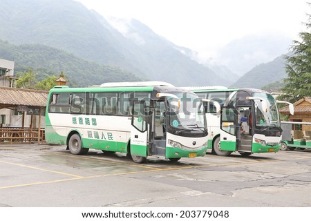 BEICHUAN,CHINA - 28 June,2014: Green travel bus before the BEICHUAN earthquake  tourist center.