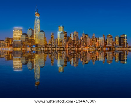 Lower Manhattan skyline at night reflected in water