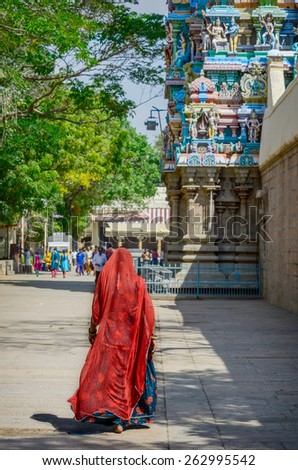 Woman in red sari at Meenakshi temple . India, Madurai, Tamil Nadu