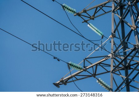 High-voltage tower isolated on blue sky background.