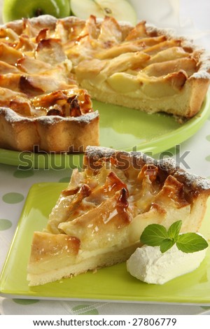 Apple pie slice with pie on background, soft focus