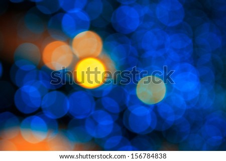 bokeh of yellow circle light on cool blue abstract blur background