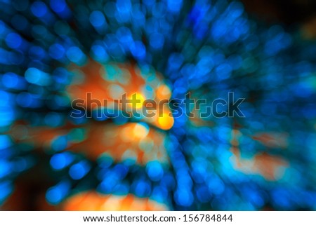 motion zoom of blue light abstract bubbles bokeh with yellow circles in the center