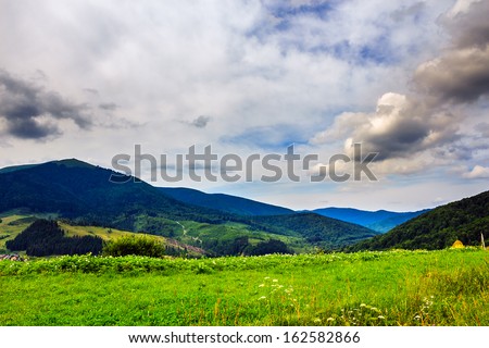 valley near forest on a steep mountain slope before the rain in morning mood