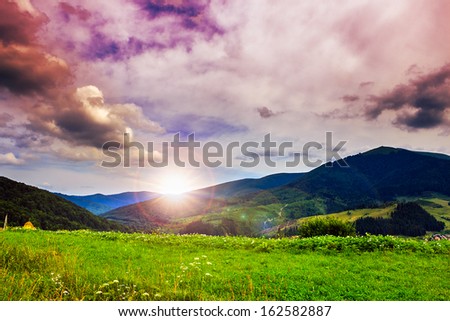 valley near forest on a steep mountain slope after the rain in evening mood