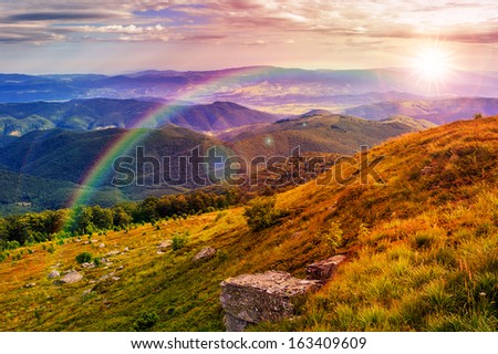 mountain landscape. valley with stones on the hillside. forest on the mountain under the beam of light falls on a clearing at the top of the hill.