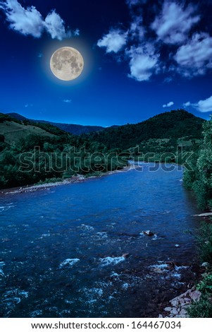 wild mountain river in mountains on a clear summer night