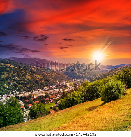 autumn landscape. village on the hillside. forest on the mountain light fall on clearing on mountains in evening