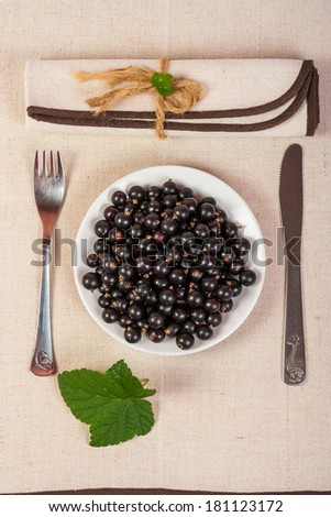 restaurant served black currants in a glass with green leaves