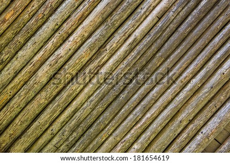 embossed texture of very old and wrinkled diagonal wooden rounded planks