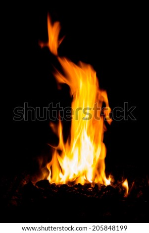 powerful high flame burning wood on black background in stoves