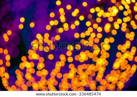 abstract background of blurred warm yellow   and cool purple lights with bokeh effect