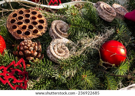 christmas background with toys, cake and fir-cones on fir tree branches with shallow depth of field