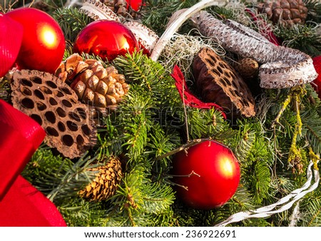 christmas background with toys, cake and fir-cones on fir tree branches with shallow depth of field