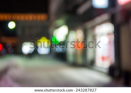 abstract empty witer city street background of blurred warm lights with hot red spot with bokeh effect