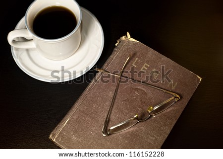 Lenin book on a table Vintage Lenin book on a black table with a pair of glasses on it and a cup of coffee next to it