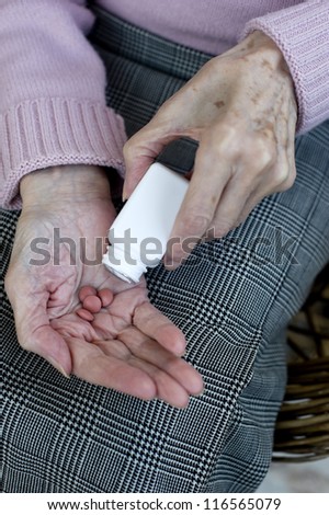 Senior woman hands Close up of senior woman\'s hands taking her medicines