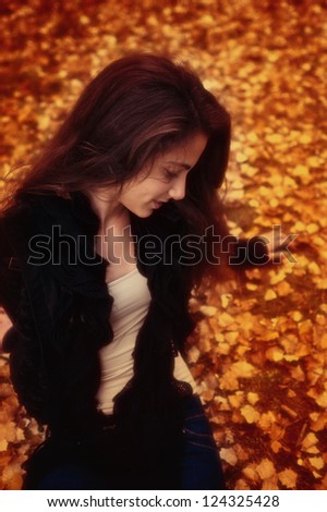 Girl posing in the countryside. A teenage girl is posing in a beautiful autumn scenery
