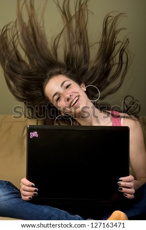 Happy teenage computer user. Teenage girl winning in a PC game