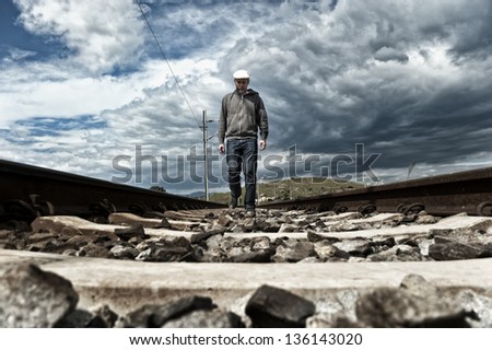 Man walking on the railway tracks