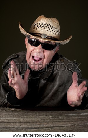 Confused man. Confused man with hat and sunglasses in black background