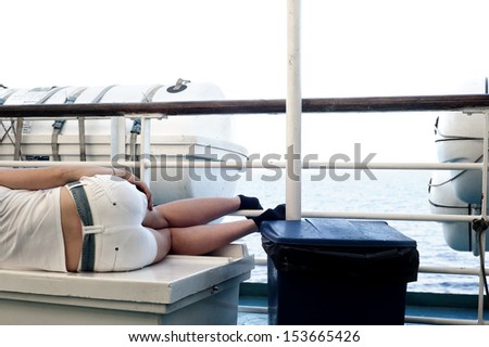 Woman lying on the deck of a passenger ship
