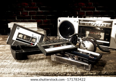 Old Cassette Tapes And Cassette Player On Wooden Surface