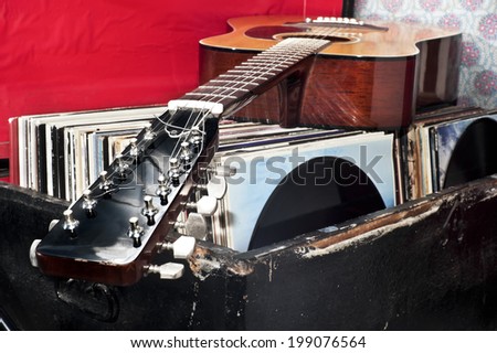 Guitar on a trunk full of old vinyl records