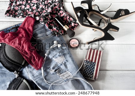 Female lingerie, clothes, high heels and accessories on floor