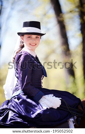 Lady on a  horse. The lady on riding walk. Portrait of the horsewoman. The woman astride a horse. The aristocrat on riding walk.