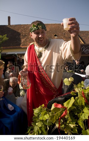 PEZINOK,SR - SEPTEMBER 28: The mythology god of wine Bacchus is raising the glass of wine at the allegorical procession during the annual vintage on September 28, 2008 in Pezinok, Slovakia.