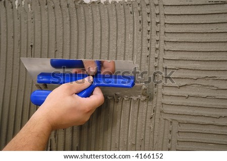 hand holding plastering tool