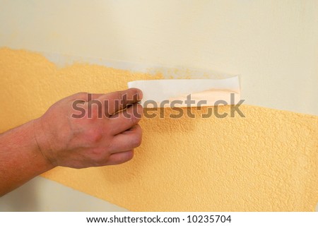 taking down scotch from the wall to finish the decoration