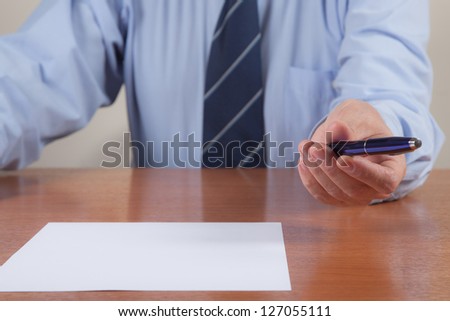 Men with pen and white sheet.