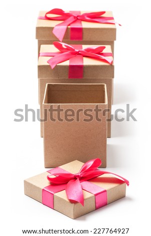 Carton gift boxes first without a lid with red ribbons isolated on white