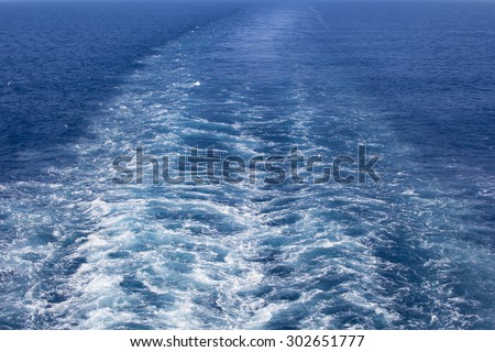 Image of a wake in the sea, caused by big ship propellers during movement.
